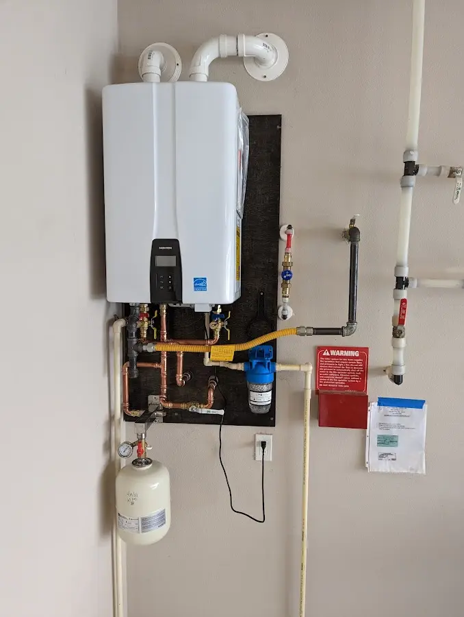 Professional plumber installing copper piping in a New Lexington home